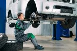car-lifted-automobile-service-fixing-worker-repairs-wheel.jpg