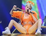 Miley-Cyrus-on-stage-wearing-an-orange-body-suite-legs-spread.jpg